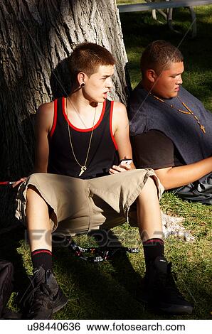 two boys males teens teenagers sitting against View Large Photo Image Stock Photograph - two boys males teens teenagers sitting against. Fotosearch