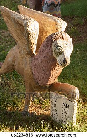 Stock Photograph -  winged dog glenn stark yard art sculpture kansas. Fotosearch