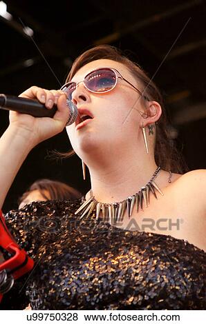Stock Photo -  woman female singing music concepto tambor group. Fotosearch