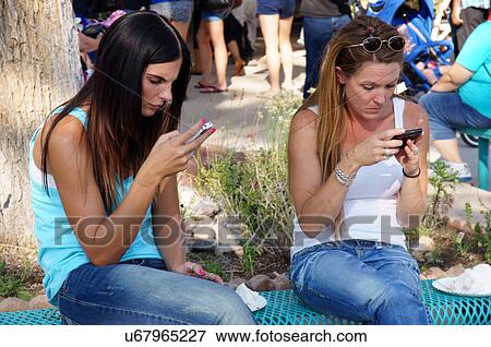 women females studying cell phone iphone android View Large Photo Image Stock Photo - women females studying cell phone iphone android. Fotosearch