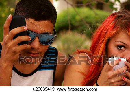 Stock Photo -  young couple cell phone iphone android mumford. Fotosearch