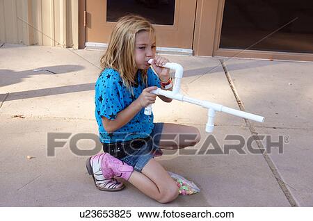 young girl child kid blowing through plastic View Large Photo Image Stock Photography - young girl child kid blowing through plastic. Fotosearch