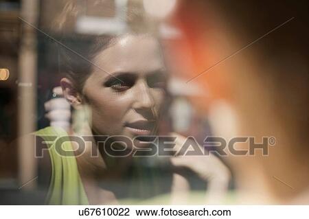 A young brunette woman sitting in a cafe looking out of the window View Large Photo Image Stock Image - A young brunette woman sitting in a cafe looking out of the window. Fotosearch
