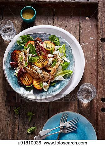 Stock Photograph - BBQ chicken, peach and cos lettuce salad. Fotosearch