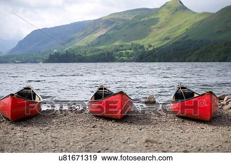 Canoes by lake edge, Lake District, Cumbria, UK View Large Photo Image Stock Photo - Canoes by lake edge, Lake District, Cumbria, UK. Fotosearch