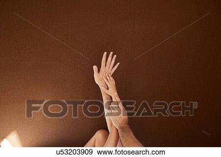 Stock Photo - Child's and man's hands on each other. Fotosearch