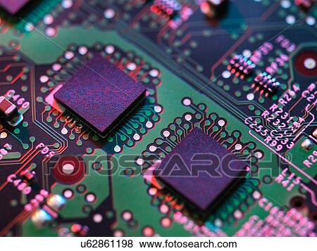 Stock Photo - Close up detail of purple and green computer circuit board. Fotosearch