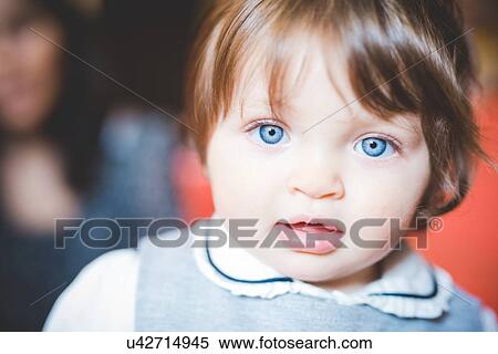 Stock Photography - Close up portrait of female toddler with blue eyes. Fotosearch