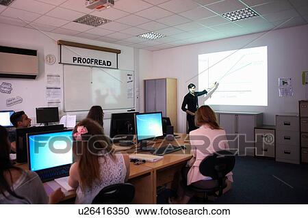 Stock Image - Computer teaching presenting in class. Fotosearch
