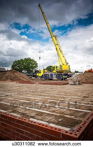 Stock Image - Crane on construction site. Fotosearch