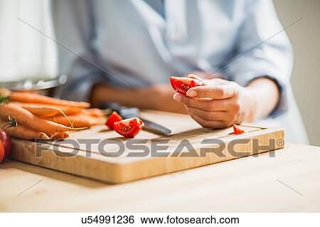 Cropped shot of full term pregnancy young woman slicing tomato in kitchen View Large Photo Image Stock Photograph - Cropped shot of full term pregnancy young woman slicing tomato in kitchen. Fotosearch