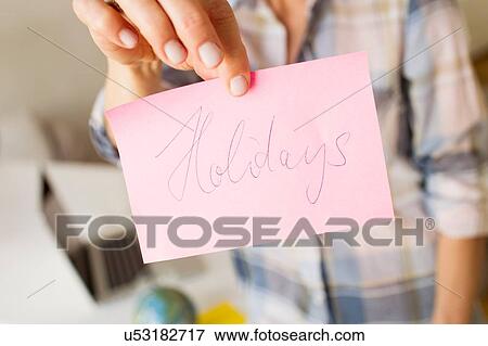 Cropped view of mature womans hands holding handwritten note with the word holidays View Large Photo Image Stock Photo - Cropped view of mature womans hands holding handwritten note with the word holidays. Fotosearch
