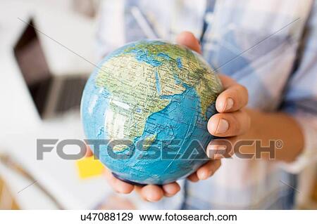 Cropped view of mature women hands holding small globe View Large Photo Image Stock Photo - Cropped view of mature women hands holding small globe. Fotosearch