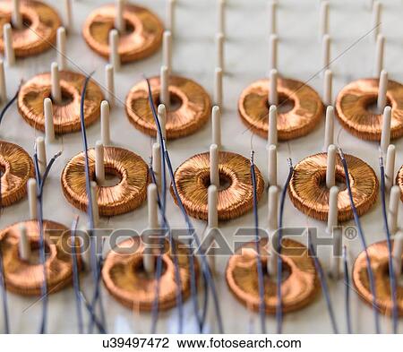 Stock Image - Electromagnetic coils on production line in electromagnetics factory, close-up. Fotosearch