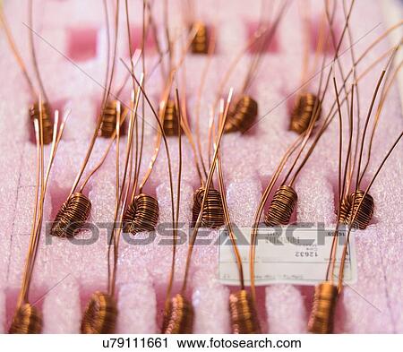 Electromagnetic coils on production line in electromagnetics factory, close-up View Large Photo Image Stock Image - Electromagnetic coils on production line in electromagnetics factory, close-up. Fotosearch