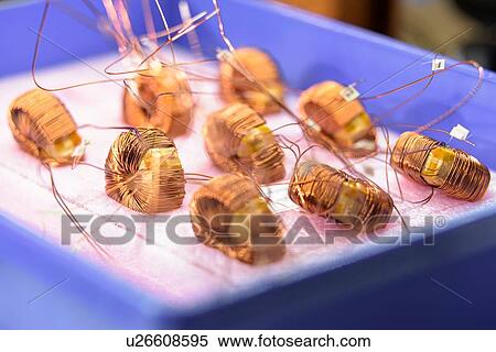 Electromagnetic coils on production line in electromagnetics factory, close-up View Large Photo Image Stock Photography - Electromagnetic coils on production line in electromagnetics factory, close-up. Fotosearch