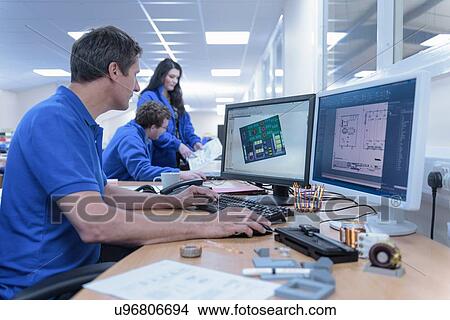 Electronics designers with CAD imagery in electronics factory View Large Photo Image Picture - Electronics designers with CAD imagery in electronics factory. Fotosearch