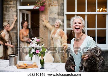 Elegant mature women enjoying champagne in urban garden View Large Photo Image Stock Photo - Elegant mature women enjoying champagne in urban garden. Fotosearch
