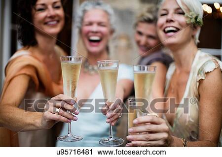 Elegant mature women toasting in urban garden View Large Photo Image Stock Image - Elegant mature women toasting in urban garden. Fotosearch