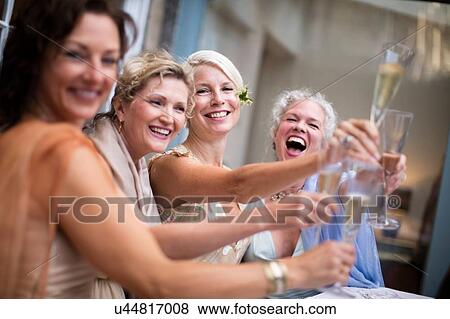 Elegant mature women toasting in urban garden View Large Photo Image Stock Photo - Elegant mature women toasting in urban garden. Fotosearch