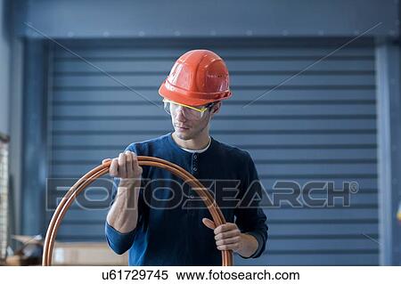 Stock Photography - Factory engineer inspecting power cable. Fotosearch