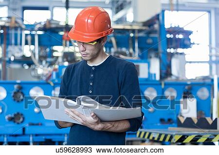 Factory engineer reading machinery instruction manual View Large Photo Image Stock Image - Factory engineer reading machinery instruction manual. Fotosearch