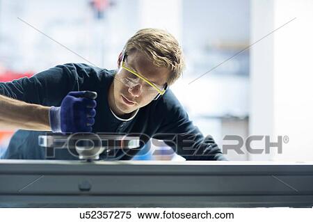 Stock Photography - Factory engineer testing machinery in factory. Fotosearch