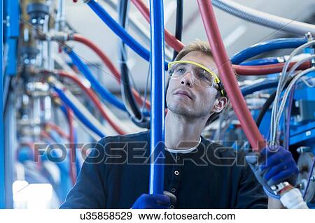 Factory technician checking network cables View Large Photo Image Stock Photo - Factory technician checking network cables. Fotosearch