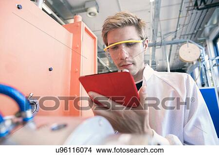 Factory technician using digital tablet View Large Photo Image Picture - Factory technician using digital tablet. Fotosearch