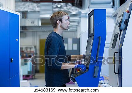 Stock Photo - Factory technician working on control panel. Fotosearch
