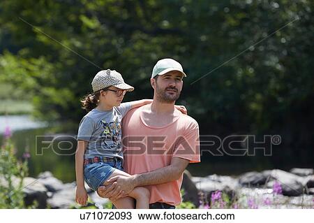 Stock Image - Father and daughter beside stream, Saut Deth Pish, Valle de Aran, Spain. Fotosearch