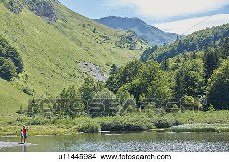 Father and daughter enjoying lake, Valle de Aran, Spain View Large Photo Image Picture - Father and daughter enjoying lake, Valle de Aran, Spain. Fotosearch