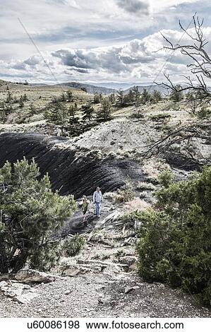 Stock Photo - Father and son hiking among rock formations, Bridger, Montana, USA. Fotosearch
