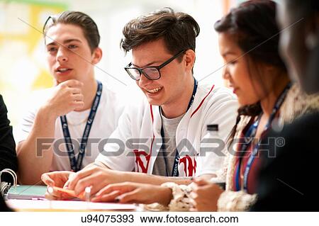 Female and male students working together in class View Large Photo Image Stock Image - Female and male students working together in class. Fotosearch