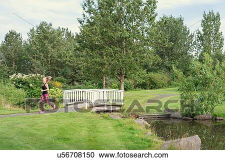 Female runner running in park View Large Photo Image Stock Image - Female runner running in park. Fotosearch