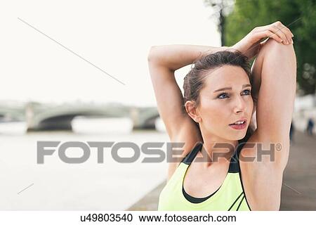 Female runner stretching arms on Southbank, London, UK View Large Photo Image Stock Image - Female runner stretching arms on Southbank, London, UK. Fotosearch