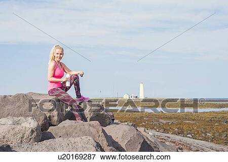 Female runner taking a break at coast View Large Photo Image Stock Photo - Female runner taking a break at coast. Fotosearch