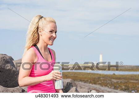 Female runner taking a water break at coast View Large Photo Image Stock Image - Female runner taking a water break at coast. Fotosearch