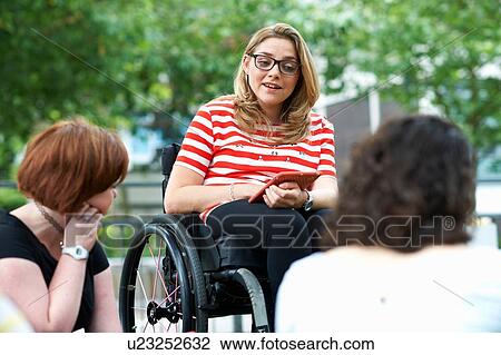 Female student in wheelchair chatting to friends on college campus View Large Photo Image Stock Image - Female student in wheelchair chatting to friends on college campus. Fotosearch