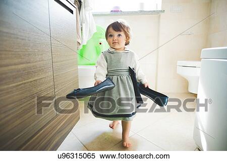 Female toddler carrying ladies shoes at home View Large Photo Image Stock Photography - Female toddler carrying ladies shoes at home. Fotosearch