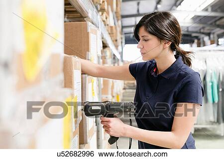 Female warehouse worker using barcode scanner on box in distribution warehouse View Large Photo Image Stock Photograph - Female warehouse worker using barcode scanner on box in distribution warehouse. Fotosearch