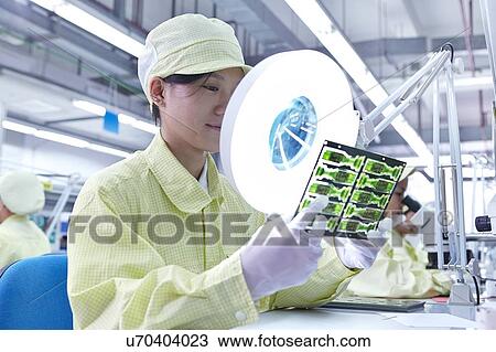 Female worker using magnifying glass at quality check station for a factory producing flexible electronic circuit boards. Plant is located in the south of China, in Zhuhai, Guangdong province View Large Photo Image Stock Image - Female worker using magnifying glass at quality check station for a factory producing flexible electronic circuit boards. Plant is located in the south of China, in Zhuhai, Guangdong province. Fotosearch