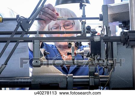 Female worker winding electromagnetic coils in electronics factory View Large Photo Image Stock Image - Female worker winding electromagnetic coils in electronics factory. Fotosearch