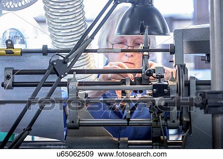 Female worker winding electromagnetic coils in electronics factory View Large Photo Image Stock Photo - Female worker winding electromagnetic coils in electronics factory. Fotosearch