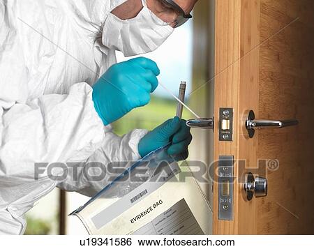 Stock Photograph - Forensic officer taking DNA swab off door handle. Fotosearch