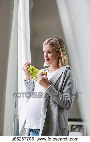 Full term pregnancy young woman eating grapes View Large Photo Image Stock Photograph - Full term pregnancy young woman eating grapes. Fotosearch