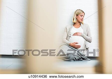 Full term pregnancy young woman sitting on floor View Large Photo Image Stock Photograph - Full term pregnancy young woman sitting on floor. Fotosearch