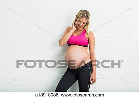 Full term pregnancy young woman wearing sports clothing View Large Photo Image Stock Photograph - Full term pregnancy young woman wearing sports clothing. Fotosearch