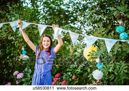 Girl decorating garden for summer party View Large Photo Image Stock Image - Girl decorating garden for summer party. Fotosearch