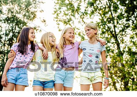 Girls chatting on field, Flanders, Belgium View Large Photo Image Stock Photo - Girls chatting on field, Flanders, Belgium. Fotosearch